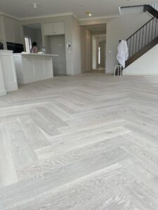 Elegant herringbone flooring installation in a Dubai modern living room